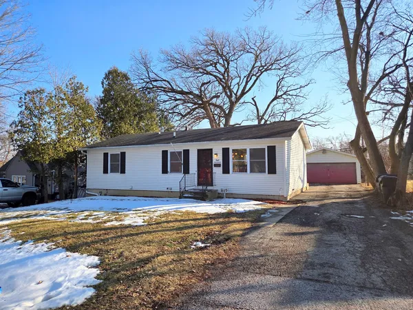 a view of a house with a yard covered with snow in front of house