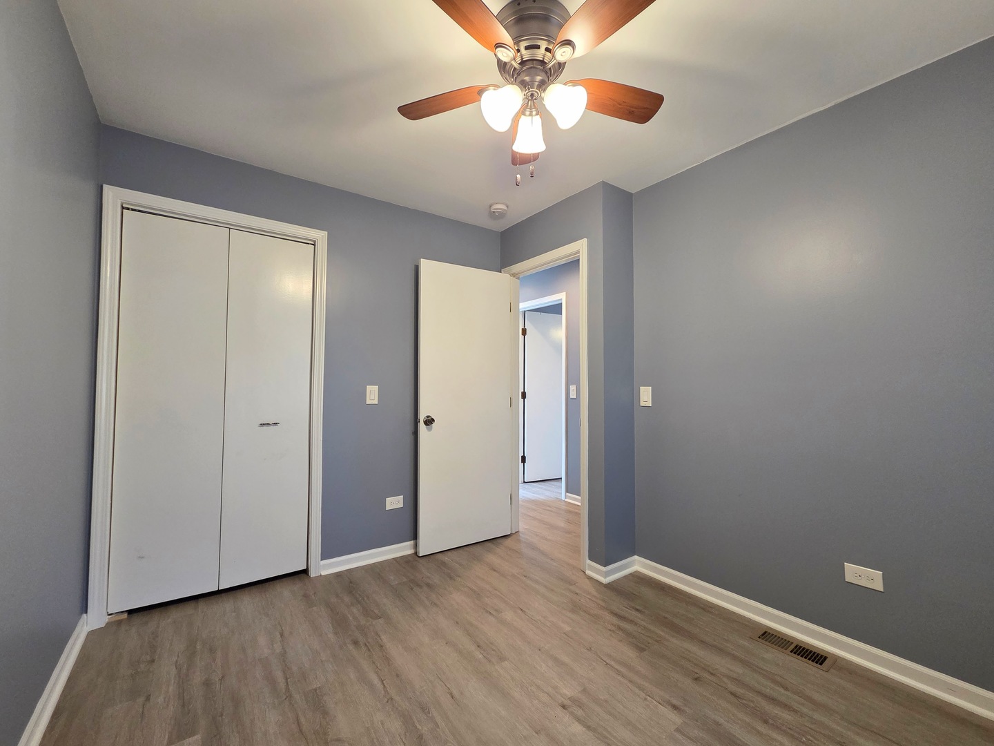 817 Tomahawk Trail Round Lake Heights, IL 60073 - Photo 12 of 22 a view of an empty room with window and wooden floor