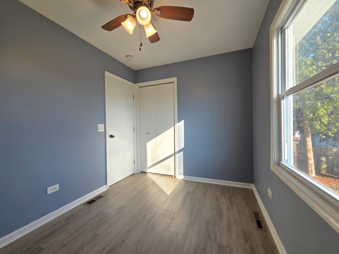 817 Tomahawk Trail Round Lake Heights, IL 60073 - Photo 14 of 22 an empty room with wooden floor and windows
