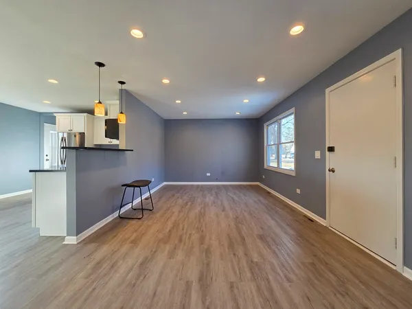a view of a kitchen with a sink and wooden floor