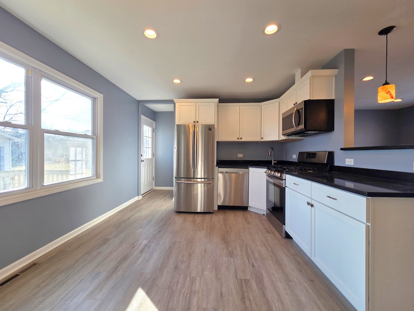 817 Tomahawk Trail Round Lake Heights, IL 60073 - Photo 6 of 22 a kitchen with granite countertop a stove a sink a refrigerator and a microwave