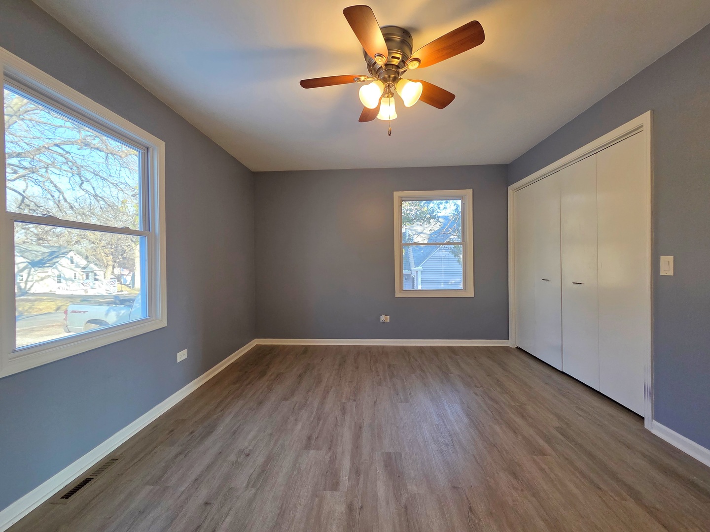 817 Tomahawk Trail Round Lake Heights, IL 60073 - Photo 8 of 22 a view of an empty room with wooden floor and a window