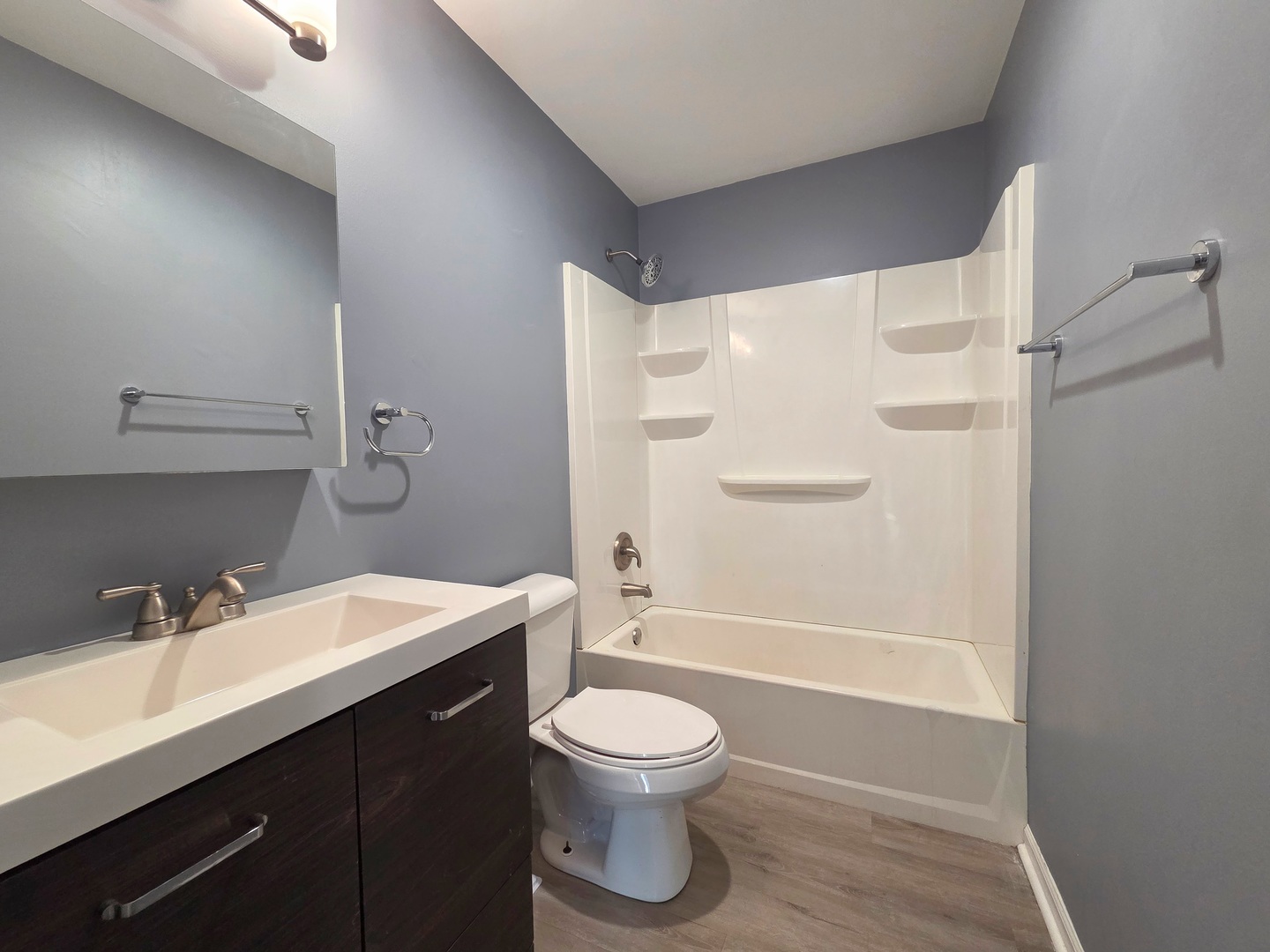 817 Tomahawk Trail Round Lake Heights, IL 60073 - Photo 10 of 22 a bathroom with a sink a toilet and a large mirror
