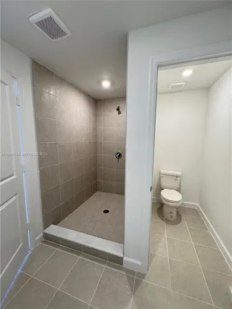 a bathroom with a shower and a toilet