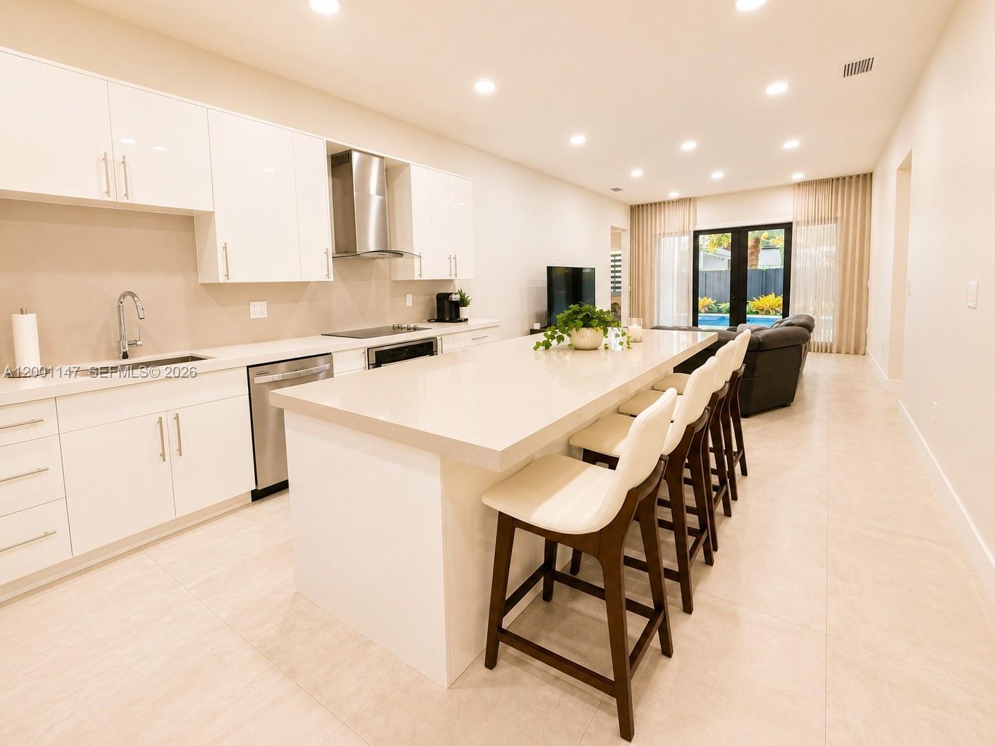 14531 Southwest 21st Street Miami, FL 33175 - Photo 15 of 25 a kitchen with a dining table chairs sink and cabinets