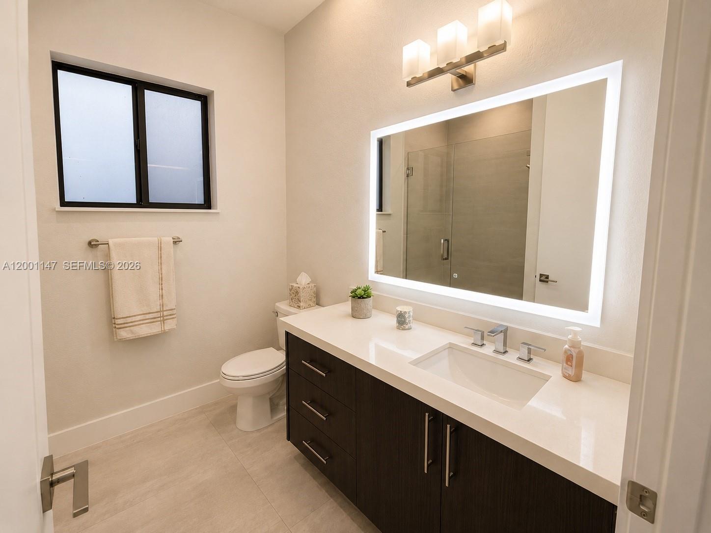 14531 Southwest 21st Street Miami, FL 33175 - Photo 20 of 25 a bathroom with a double vanity sink toilet and mirror