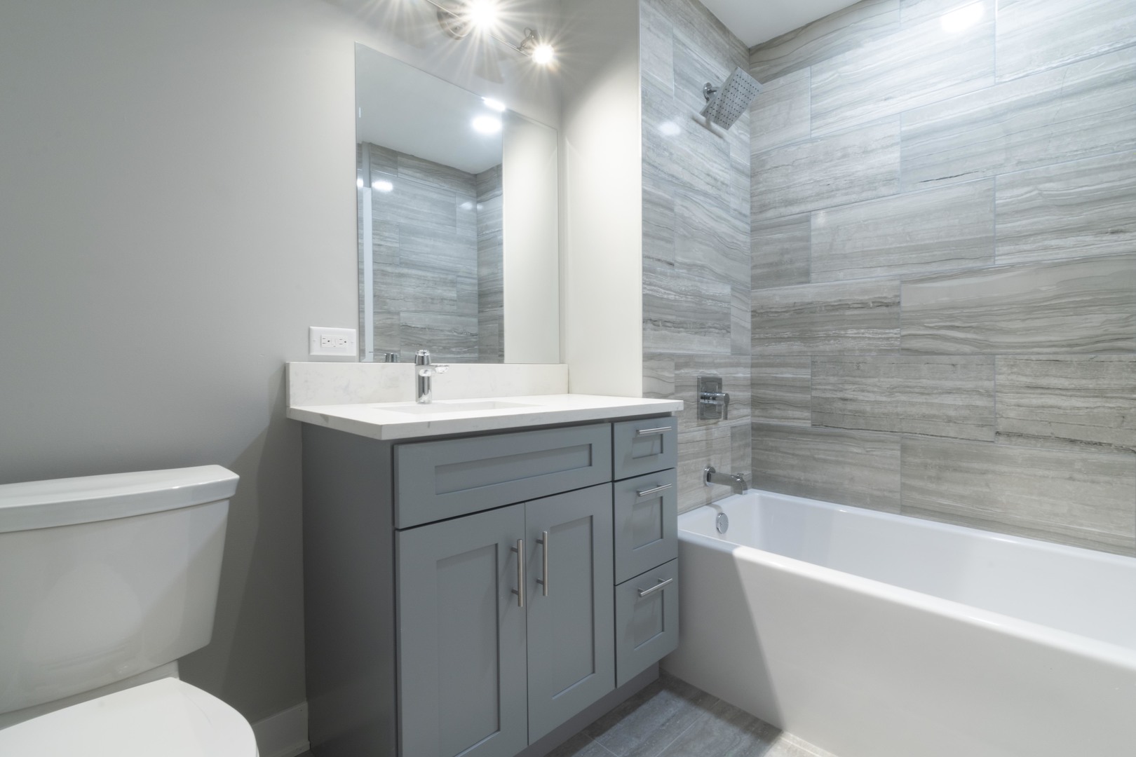 23 West Hubbard Street, Unit 4A Chicago, IL 60654 - Photo 7 of 8 a bathroom with a sink toilet vanity and bathtub