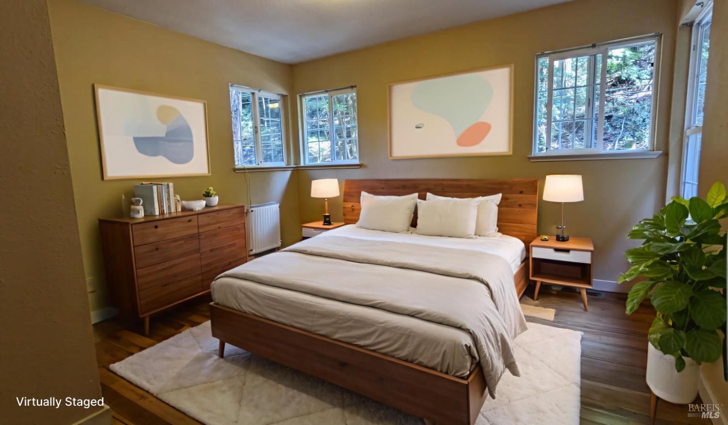 19026 Hidden Valley Road Guerneville, CA 95446 - Photo 12 of 23 a bedroom with a bed and wooden floor