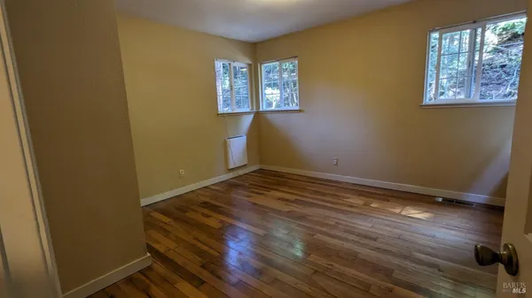 a bedroom with a bed and a painting on the wall