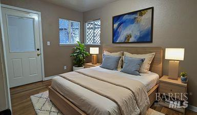 19026 Hidden Valley Road Guerneville, CA 95446 - Photo 15 of 23 a bedroom with a bed and a painting on the wall