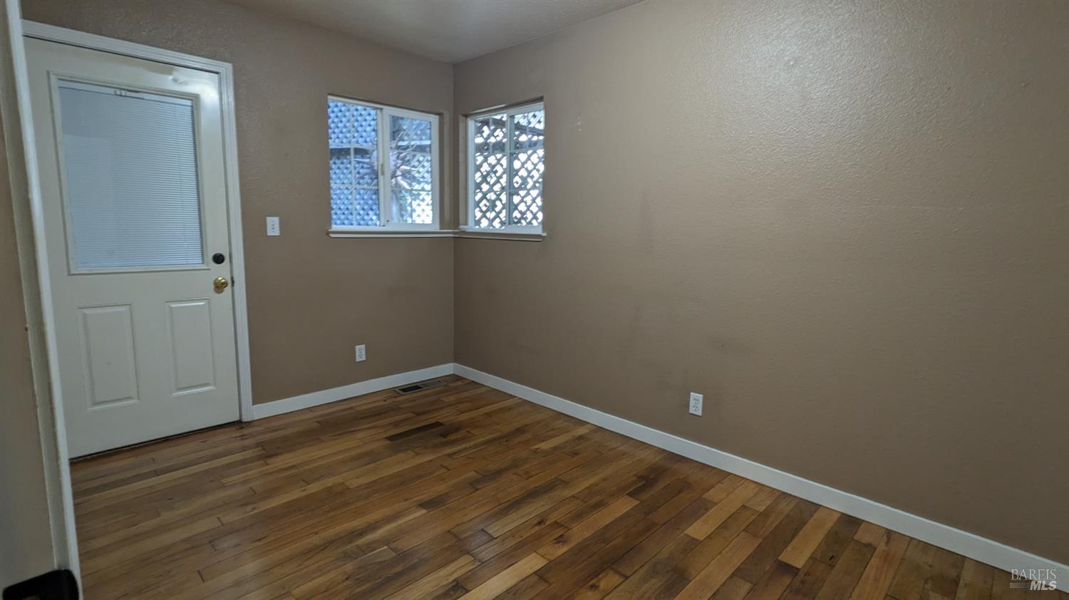 19026 Hidden Valley Road Guerneville, CA 95446 - Photo 16 of 23 a view of an empty room with wooden floor and a window