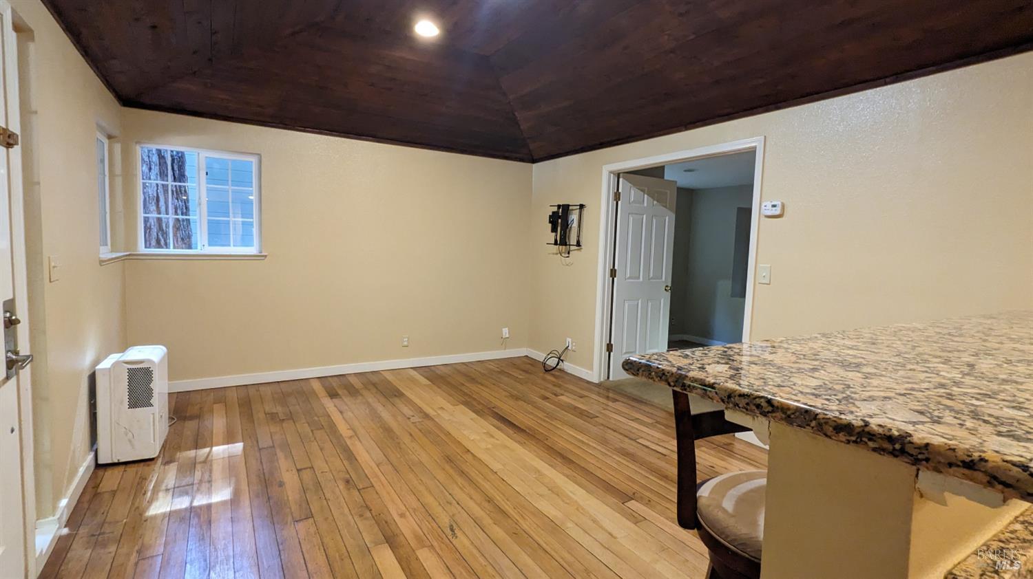 19026 Hidden Valley Road Guerneville, CA 95446 - Photo 19 of 23 a view of an empty room with wooden floor