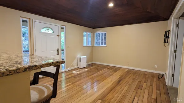 a view of a kitchen with dining space and wooden floor