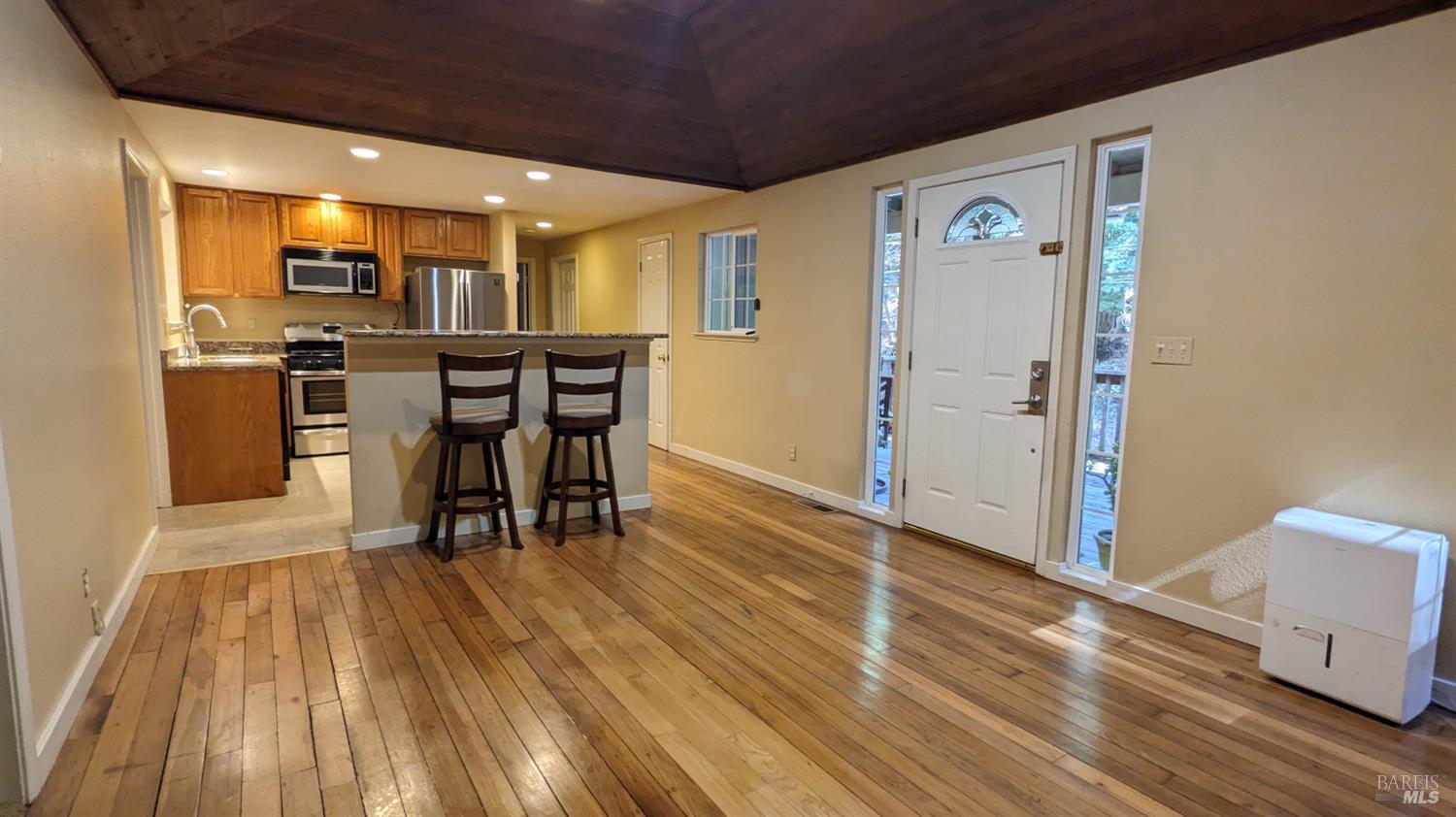 19026 Hidden Valley Road Guerneville, CA 95446 - Photo 8 of 23 a view of a kitchen with dining space and wooden floor