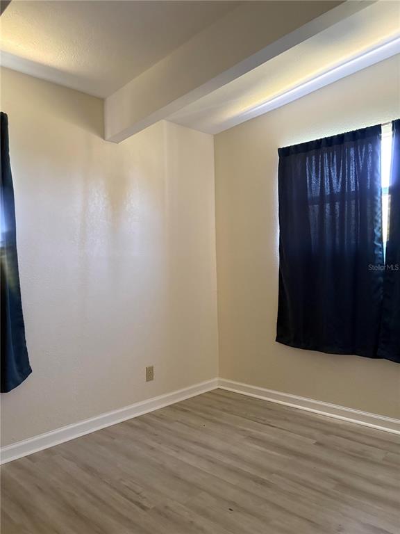 503 Myrtle Street Punta Gorda, FL 33950 - Photo 17 of 17 a view of an empty room with wooden floor and a window