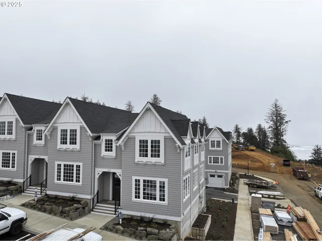 a view of a white house next to a road
