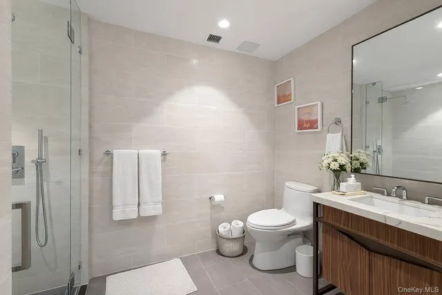 a bathroom with a toilet a sink and a mirror