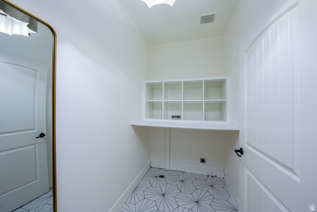 868 Braddock Lane Alpine, UT 84004 - Photo 35 of 64 Built-in shelving with cubby storage, white countertop, geometric tile flooring, and white paneled doors