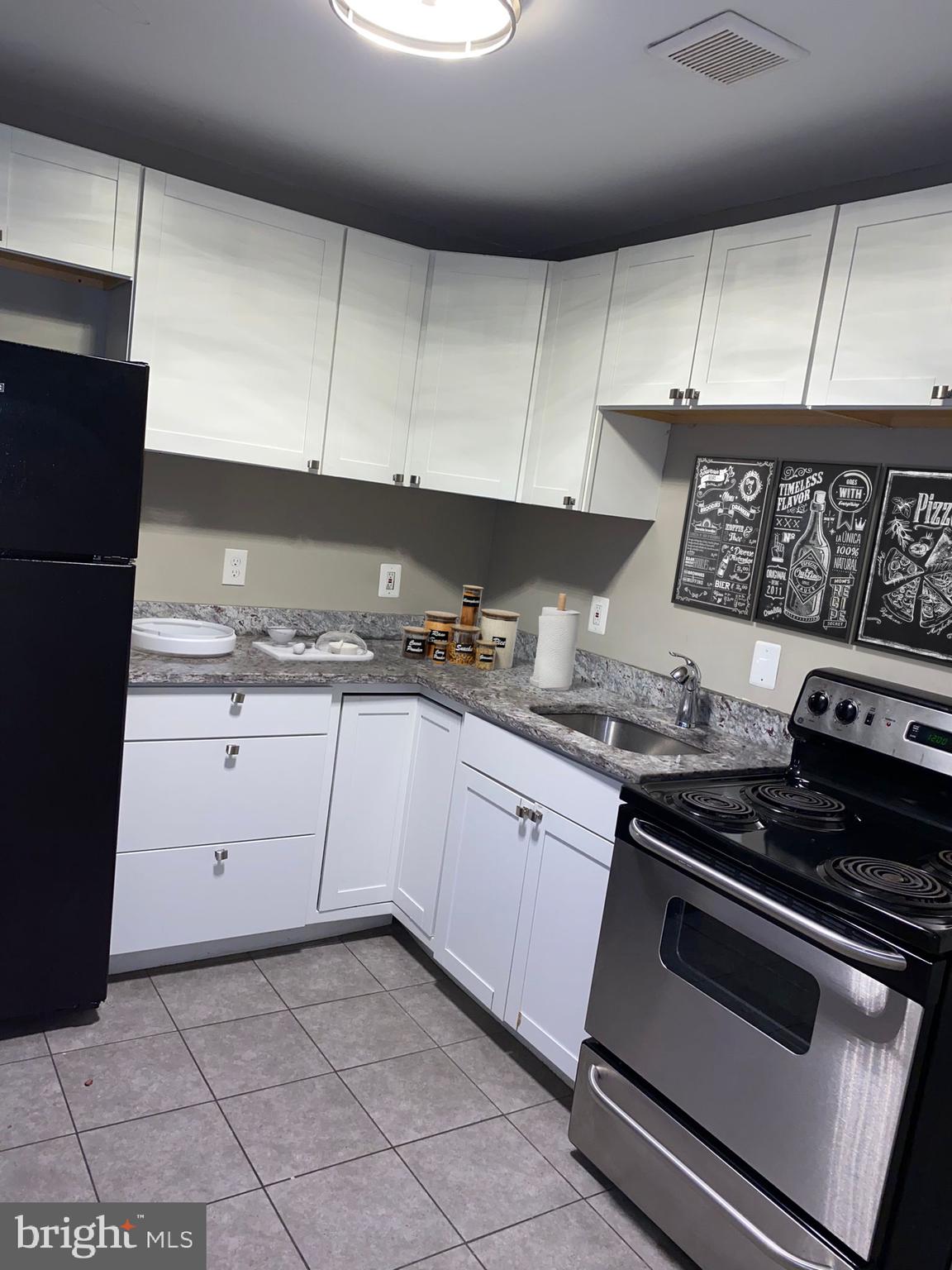 3536 Overview Road Baltimore, MD 21215 - Photo 4 of 11 a kitchen with granite countertop a stove sink and cabinets