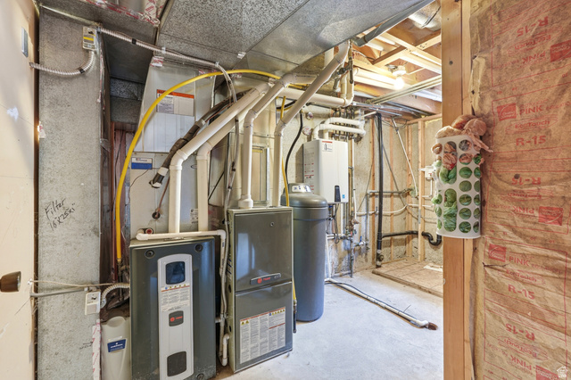 1410 Sumac Drive Logan, UT 84321 - Photo 17 of 28 Utility room featuring a water heater, furnace, water softener, tankless water heater, and exposed ceiling joists