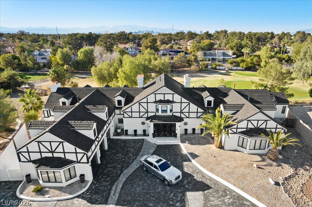3003 Regency Hill Henderson, NV 89014 - Photo 12 of 13 An architectural marvel, this sprawling estate showcases Tudor-style accents and a manicured golf course backdrop.