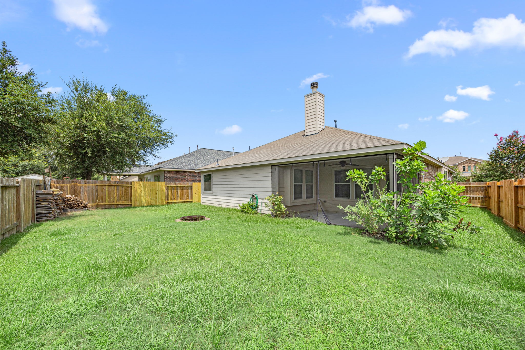 2211 Oak Rise Drive Conroe, TX 77304 - Photo 25 of 29 Backyard with mature trees and green lawn