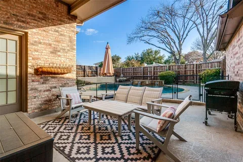 a view of a patio with a table and chairs
