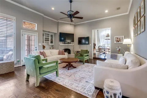 a living room with furniture a flat screen tv and a window