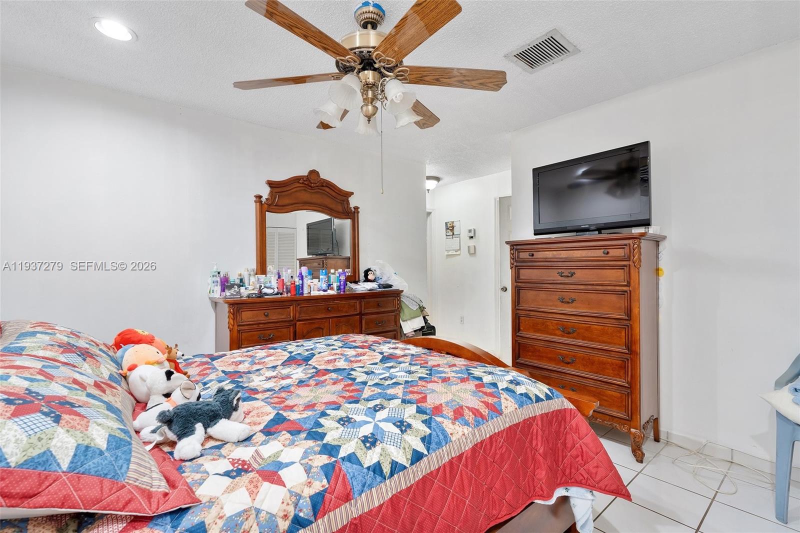 14256 Southwest 92nd Street Miami, FL 33176 - Photo 20 of 56 a bedroom with a bed and a flat screen tv