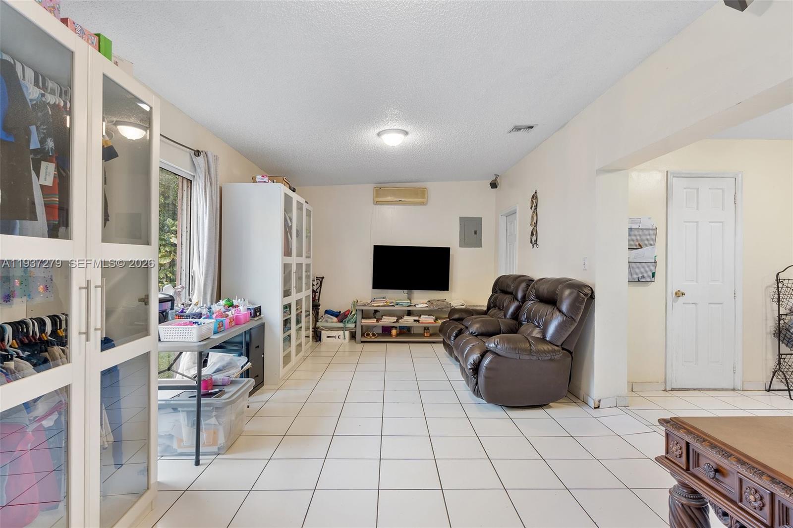 14256 Southwest 92nd Street Miami, FL 33176 - Photo 21 of 56 a living room with furniture and a flat screen tv