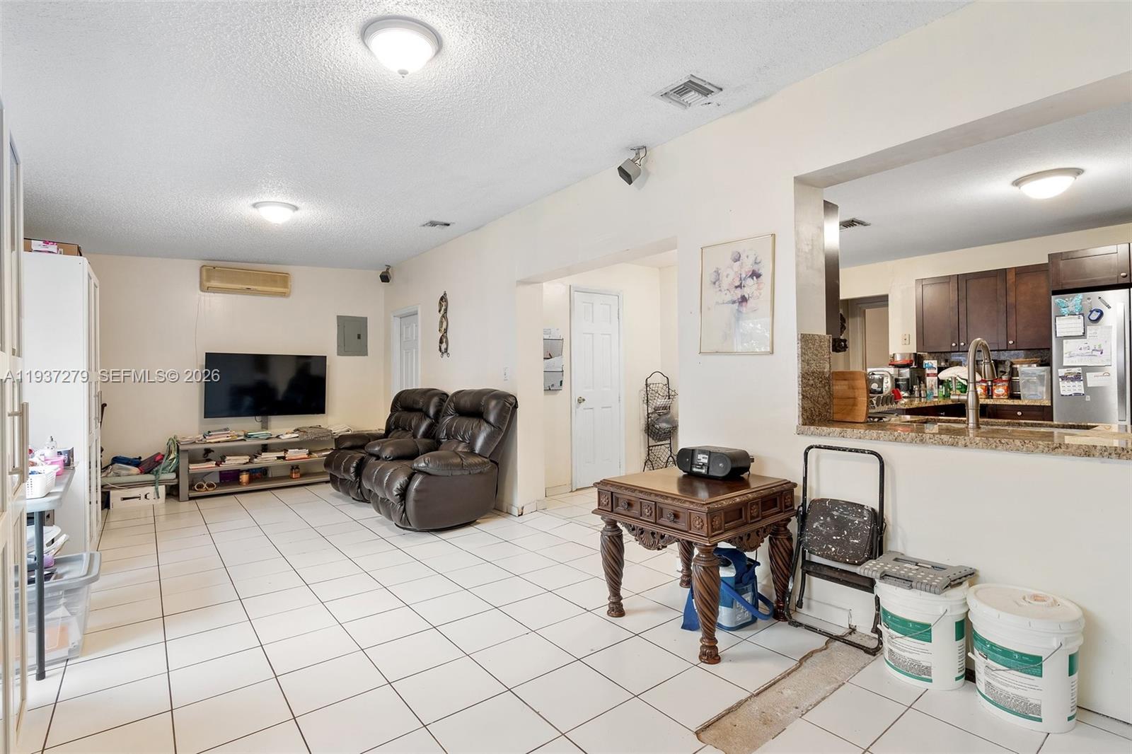 14256 Southwest 92nd Street Miami, FL 33176 - Photo 24 of 56 a living room with furniture and a flat screen tv