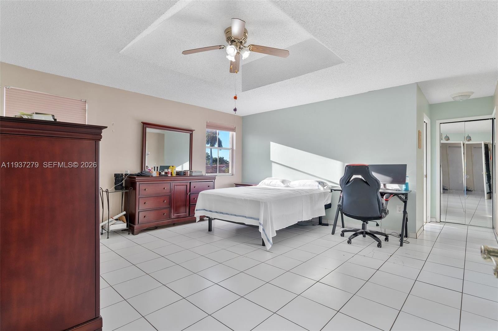 14256 Southwest 92nd Street Miami, FL 33176 - Photo 25 of 56 a bedroom with a bed and chair