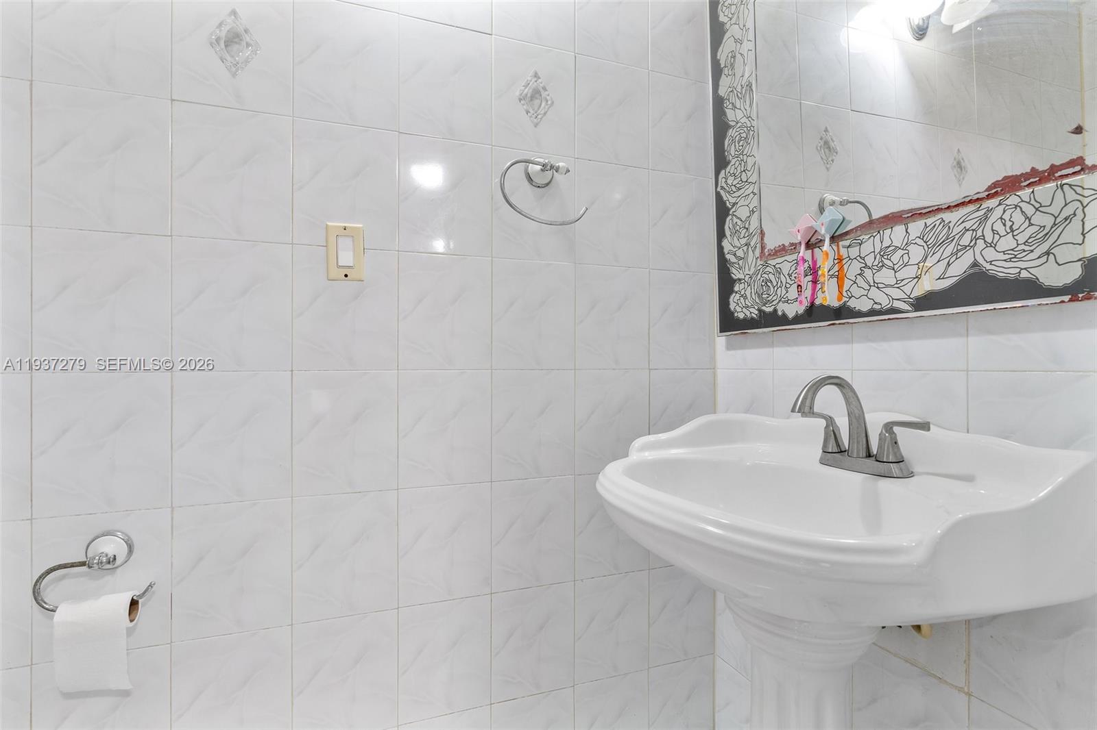 14256 Southwest 92nd Street Miami, FL 33176 - Photo 39 of 56 a bathroom with a sink and a mirror