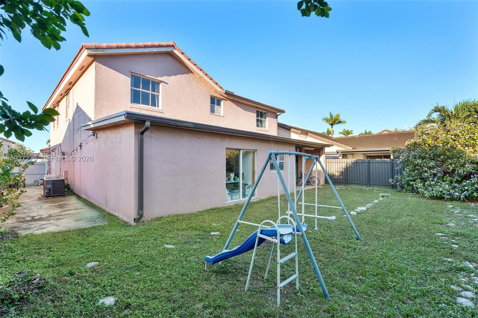 14256 Southwest 92nd Street Miami, FL 33176 - Photo 40 of 56 a backyard of a house with table and chairs