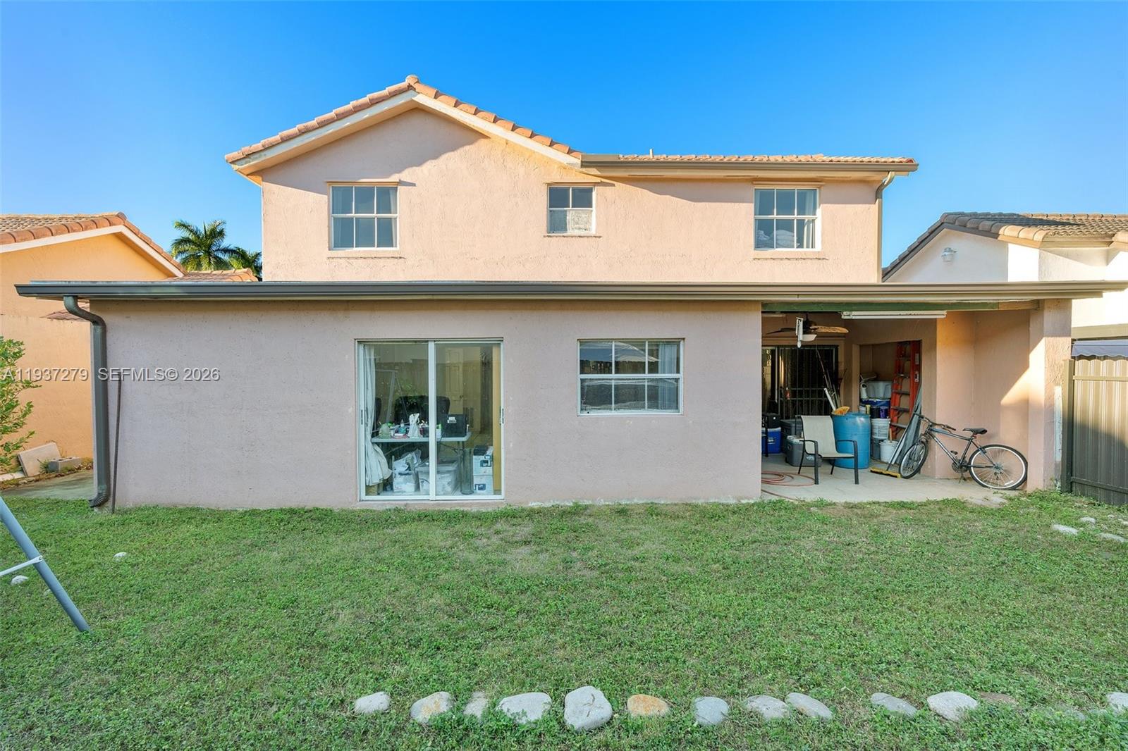 14256 Southwest 92nd Street Miami, FL 33176 - Photo 41 of 56 a front view of house with yard and outdoor seating