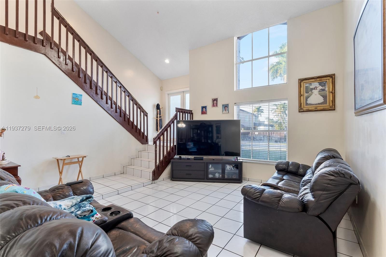 14256 Southwest 92nd Street Miami, FL 33176 - Photo 7 of 56 a living room with furniture and a flat screen tv