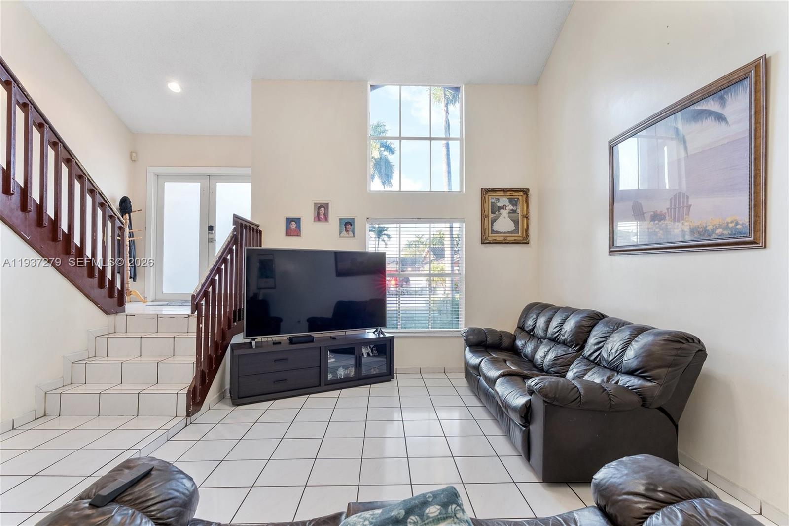14256 Southwest 92nd Street Miami, FL 33176 - Photo 10 of 56 a living room with furniture and a flat screen tv