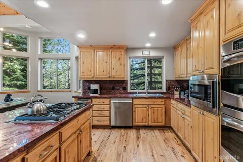 a kitchen with stainless steel appliances granite countertop a refrigerator sink and cabinets