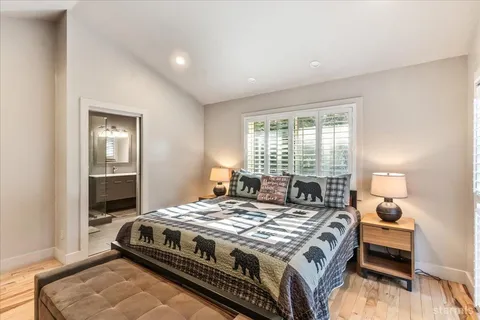 a bathroom with a double vanity sink toilet mirror and bathtub