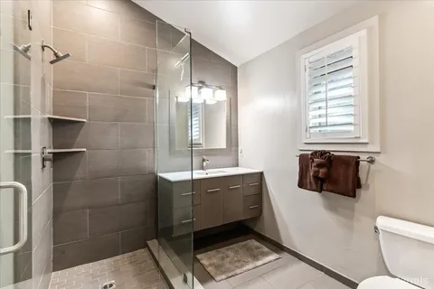 a bathroom with a sink toilet and shower