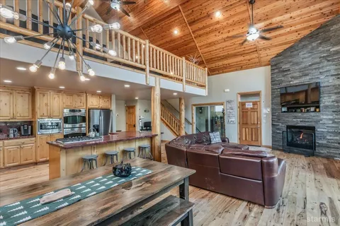 a living room with fireplace furniture and a wooden floor