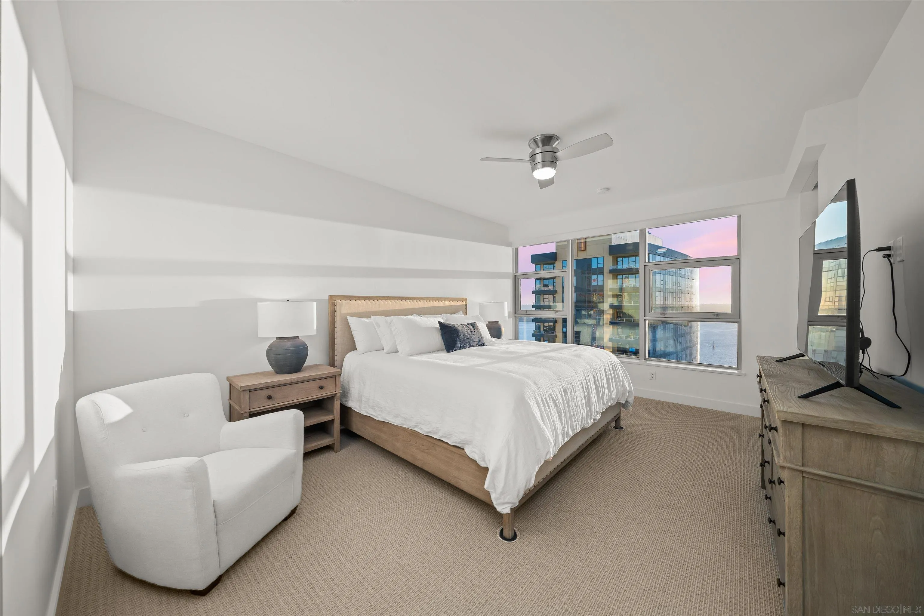 1388 Kettner Boulevard, Unit 3205 San Diego, CA 92101 - Photo 17 of 53 a bedroom with a bed flat screen tv and window