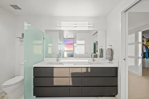 a bathroom with a sink vanity granite and a mirror