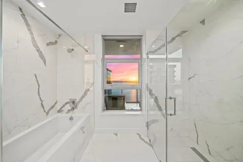 a bathroom with a bathtub and a shower
