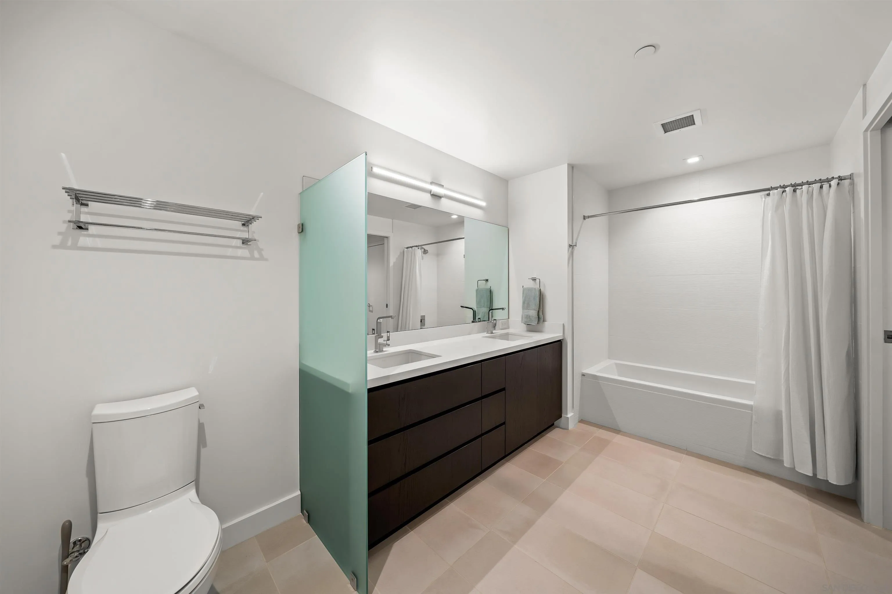 1388 Kettner Boulevard, Unit 3205 San Diego, CA 92101 - Photo 33 of 53 a bathroom with a sink a toilet and shower