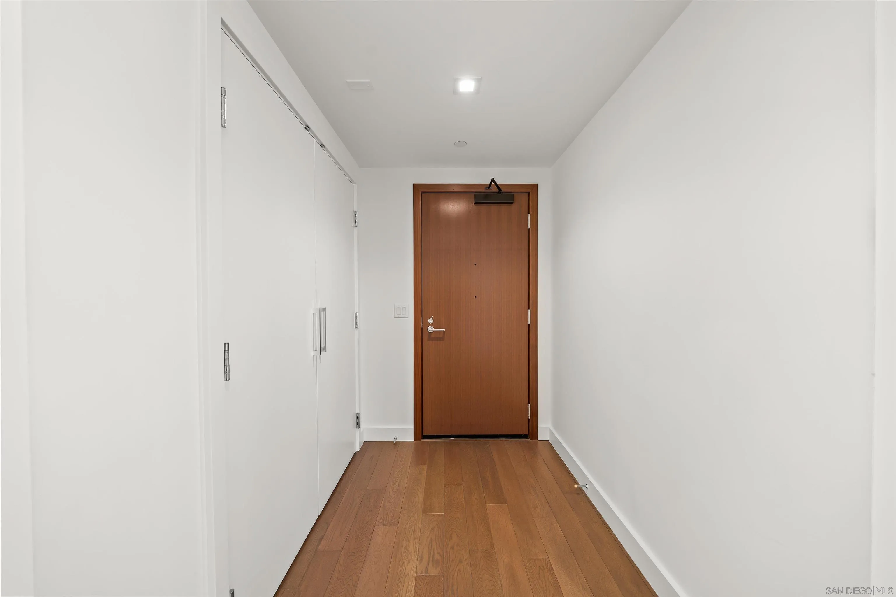 1388 Kettner Boulevard, Unit 3205 San Diego, CA 92101 - Photo 34 of 53 a view of a hallway with wooden floor
