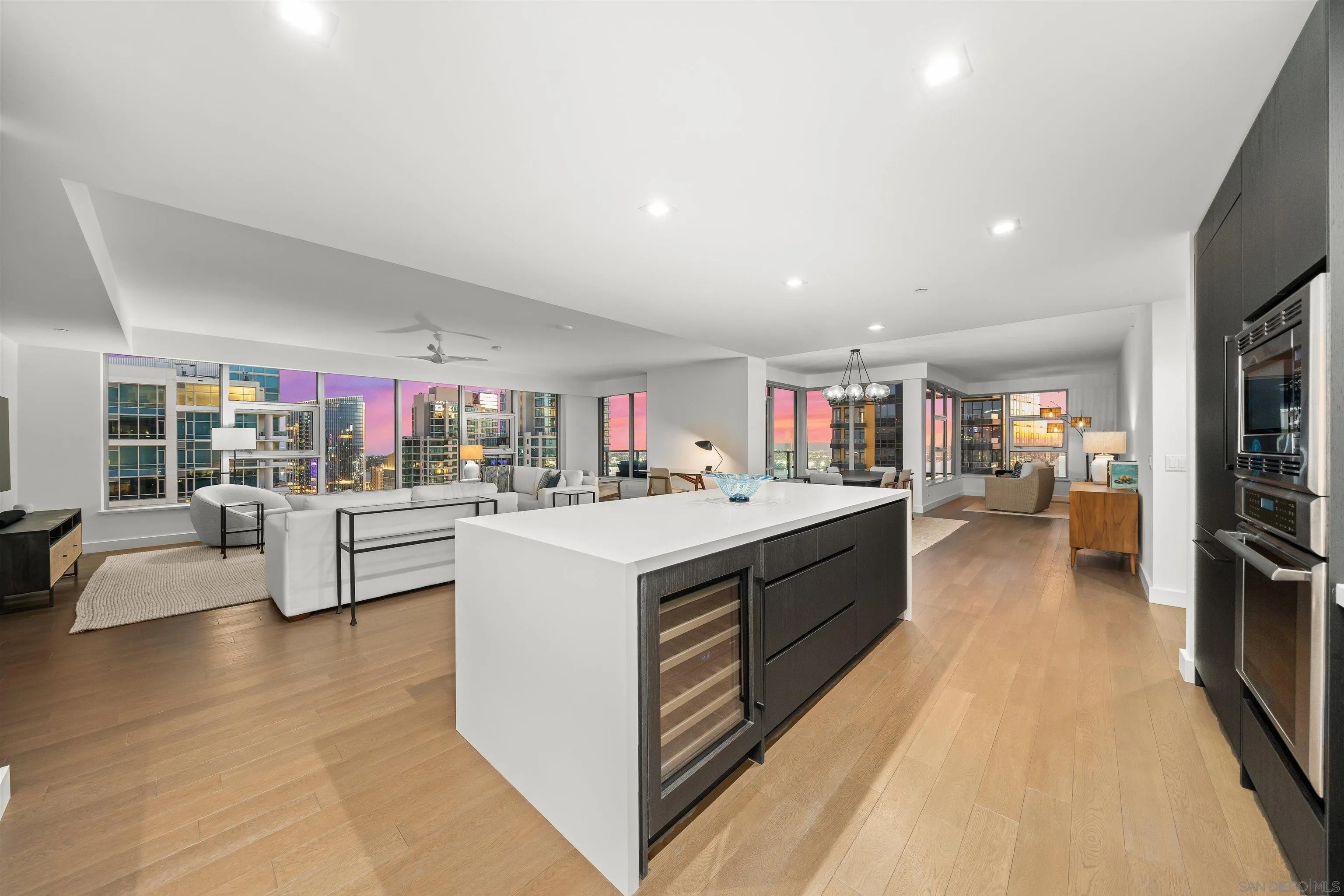 1388 Kettner Boulevard, Unit 3205 San Diego, CA 92101 - Photo 8 of 53 a open kitchen with stainless steel appliances kitchen island a large white counter top and living room view