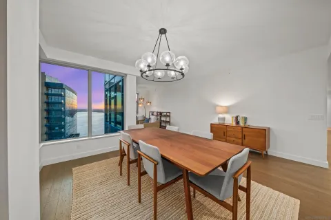 a view of a dining room with furniture wooden floor and chandelier