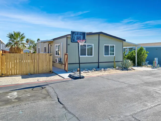 a living room with furniture a dining table and wooden floor