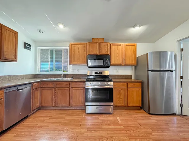a bedroom with a bed and a tv on the dresser